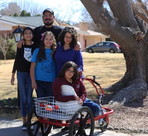 The Holguin family is pictured outside their home on Capri Arc in Mesilla on Friday, Feb. 21, 2021.