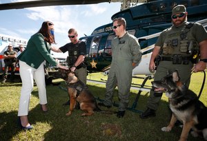 Florida Attorney General Ashley Moody (left, in foreground) joined dozens of K-9 officers Friday in showing support for a bill that would allow EMS providers to transport K-9s injured in the line of duty.