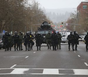 Law enforcement officers break up a crowd of over 100 demonstrators that gathered at the Capitol in Salem Sunday, March 28, to counter-protest a planned right-wing motorcade that started in Sandy.