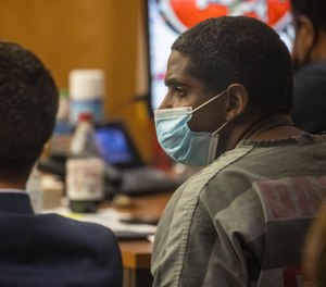 Former Dallas police officer Bryan Riser, right, sits with his defense counsel during an examining trial at the Frank Crowley Courts Building on Wednesday, April 7, 2021, in Dallas.