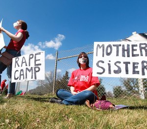 Heather Birmingham and Lisa Zittis gather outside Edna Mahan Correctional Facility for Women in Clinton, N.J., to protest abuse behind bars.