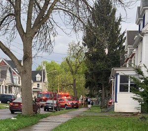 Syracuse firefighters rescued an unconscious woman from a house fire on Wednesday. Three firefighters were injured battling the blaze.