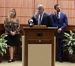Virginia Beach Commonwealth's Attorney Colin Stolle announces the start of a new opioid treatment program in the city. On the left is Aileen Smith, director of the city's Department of Human Services, and at right is Kurt Hooks, CEO of Virginia Beach Psychiatric Center.