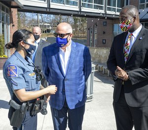 From left, Howard County Police Department s Asian community liaison officer Stella Dieu talks with Maryland Gov. Larry Hogan and County Executive Calvin Ball during a visit to Ellicott City on March 22.