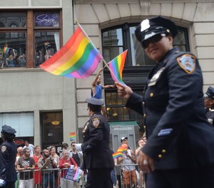An NYPD officer marches in a New York City pride parade.