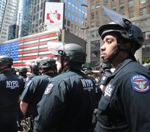 NYPD officers are seen in New York's Times Square near the NYPD booth during a 2020 summer protest.