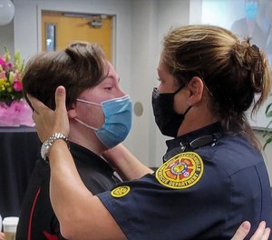 Motorcycle crash survivor Ian Brasfield hugs Jacksonville Fire and Rescue Lt. Sharon Pickering, one of the first responders who saved his life in February 2019. Three crash survivors reunited with Jacksonville and Putnam County paramedics and firefighters at Memorial Hospital Jacksonville on Wednesday.