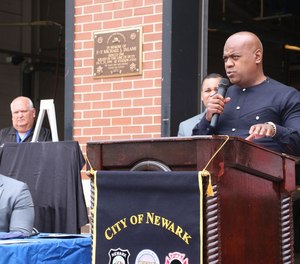 Newark Mayor Ras Baraka (right) speaks at a press conference about a new initiative that will send firefighters to life-threatening EMS calls.