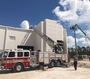 Orange County Fire Rescue responded about 11 a.m. Tuesday to Consulate Drive off South John Young Parkway, where the two workers were trapped in the bucket touching electrical wires that are still charged