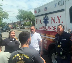 Queens dad Michael Lesner (in white T-shirt), who nearly died of a massive heart attack a week earlier, was reunited Saturday with the crew of EMS workers who saved his life.
