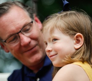 Father Matt Uber holds his daughter Vera while he is interviewed about her cardiac arrest on Thursday, June 25, 2021, at their family home in Indiana. Uber was able to remember some CPR after watching an iconic CPR episode of the office and other programs, helping to save her life.
