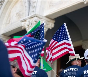 At a state Capitol rally Wednesday, corrections officers cheered the governor's decision to veto the bill.