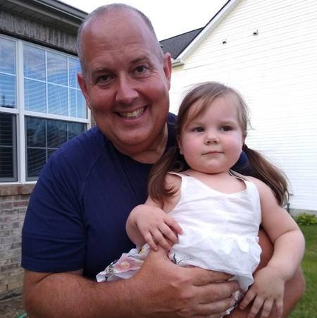 Columbus police officer Brian Wilson holds 2-year-old Carmella Lopez at their reunion upon Lopez's return home from the hospital.