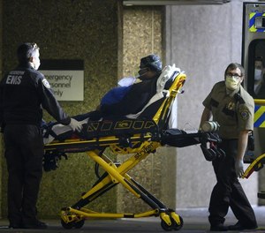 Paramedics in the longtime uniform dropped off a patient at HCMC in March 2020.