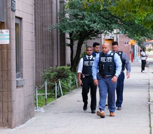 Police investigate after an officer was shot with a BB gun on Gates Ave. near Stuyvesant Ave. in Brooklyn Sunday.