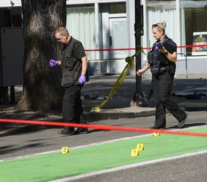 Police investigate an overnight shooting in downtown Portland on Saturday, July 17, 2021.