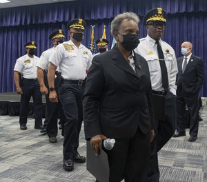 Mayor Lori Lightfoot and police Superintendent David Brown depart a news conference at police headquarters on Aug. 8, 2021, following a gunfire exchange during a traffic stop the previous night when one officer was killed and the other was seriously wounded.