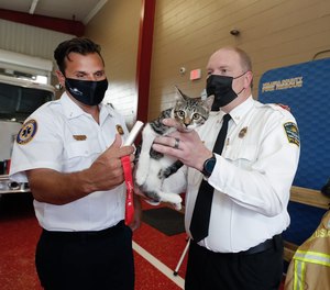 Volusia County Fire Lt. Jeremy Karaginis along with Volusia County Animal Services Director Adam Leath demonstrate the use of a microchip scanner on Pogo, Friday, August 20, 2021.
