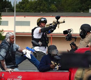 Members of the Proud Boys shoot paintballs at Antifa during a clash between left- and right-wing demonstrators in Northeast Portland on Sunday, Aug. 22, 2021.