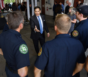Sen. Marco Rubio talks with Jacksonville Fire and Rescue personnel before the start of a Tuesday presentation at Fire Rescue Station 50 on a bill to help first responders and teachers eliminate down payments and mortgage insurance requirements to buy their first homes.