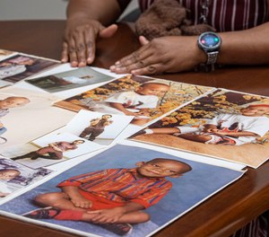 Shaleda Busbee holds a photo collage of her son, Tyrone Briggs.