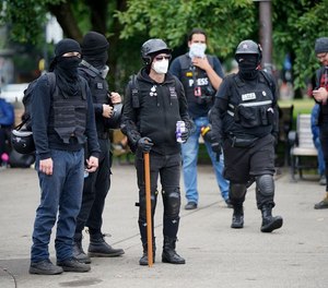 Approximately 150 dueling demonstrators gathered at Tom McCall Waterfront Park on Sunday, August 22, 2021 in Portland, Oregon.