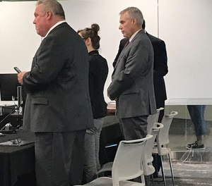 Former Cuyahoga County Jail Director Ken Mills, right, after a jury found him guilty of four misdemeanor counts in the trial where he was accused of mismanaging the county jail and lying to county council.