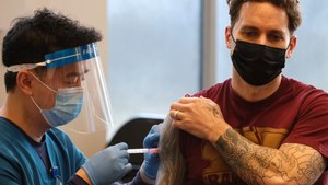 An FDNY nurse administers a dose of the COVID-19 vaccine to an FDNY firefighter at the Fire Department Headquarters in Brooklyn on Tuesday, Dec. 29, 2020.
