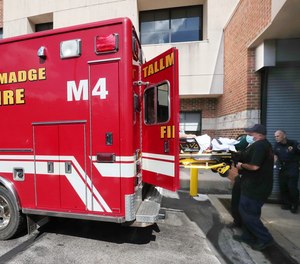Tallmadge paramedics, operating a backup unit, unload a patient Tuesday at Western Reserve Hospital in Cuyahoga Falls.