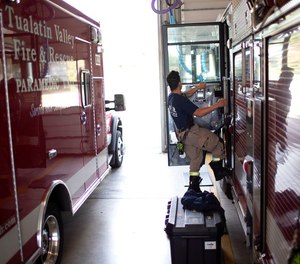 A firefighter prepares to go out on a call at Tualatin Valley Fire and Rescue’s Newberg, Ore.