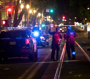 Police investigate a shooting early Saturday, July 24, 2021, in downtown Portland near Southwest Fifth Avenue and Washington Street.