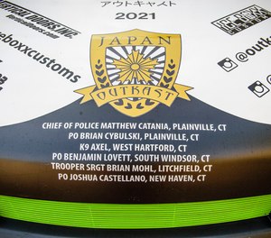 The names of slain police officers adorn the hood of Kayle Knight's 2010 Scion XB.