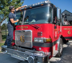 In this 2019 file photo, Stockton firefighter Andrew Schneider washes a fire engine in front of Fire Station 6 in Stockton.
