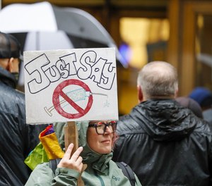 Members of the Chicago Fraternal Order of Police and supporters rally outside of City Hall Monday against the city's vaccine mandate.