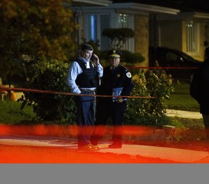 Police work the scene where a 44-year-old off-duty Chicago police officer was fatally shot in Chicago's Oriole Park neighborhood Tuesday, Nov. 2, 2021.