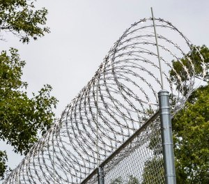 Fencing outside the Michigan Department of Corrections' Muskegon Correctional Facility and the Ernest C. Brooks Correctional Facility (or E.C. Brooks) in Muskegon on Wednesday, Aug. 5, 2020.