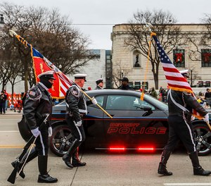 The Detroit Police Color Guard walks to the front to begin America's Thanksgiving Parade in Detroit on Thursday, Nov. 22, 2018.
