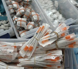 Sterile drug paraphernalia supplies given to drug users as a public health measure include, clockwise from lower left, syringes, non-latex ties, alcohol wipes, cottons, which filter out larger particles from drug solutions, cookers and sterile water ampules.