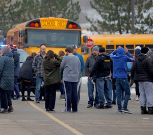 Parents wait to be reunited with their kids following an active shooter situation at Oxford High School in Oxford on November 30, 2021.