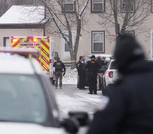 Law enforcement officers and medics on scene after an unidentified man was killed and a U.S. Marshal was wounded in an exchange of gunfire inn Columbus' Southeast Side on Wednesday, Dec. 8, 2021.