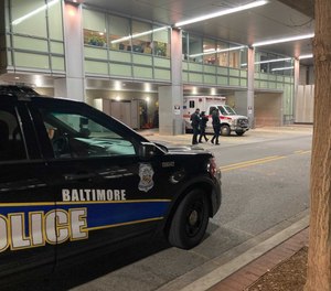 A Baltimore Police patrol vehicle is parked outside of Shock Trauma where an officer was being treated for multiple gunshot wounds after an ambush style attack on Thursday, Dec. 16.