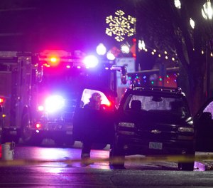 A first responder looks into a a vehicle parked on Main Street in Springfield after a report of hazardous gas in the area.