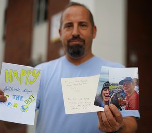 Thad Bereday holds up photos and letters from his family that he received in the mail while in serving time in federal prison on pictured on Sunday, Dec. 19, 2021 in Tampa.
