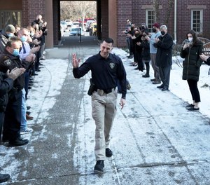 Summit Police Department Officer Anthony Pyzik was greeted with a clap when he returned to work Monday after being injured in April 2020.