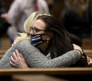 Shannon Sczyrek hugs her mother Cheryl Sczyrek after her mother testified in court.