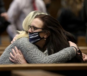 Shannon Sczyrek hugs her mother Cheryl Sczyrek after her mother testified in court.