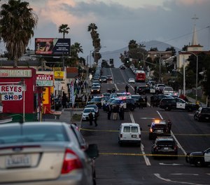 Police are seen outside Mike's Market in the Mountain View neighborhood where a shooting left one person dead on Tuesday, February 15, 2022.