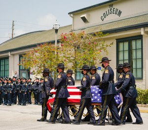 The casket of St. Petersburg Police officer Michael Weiskopf, who died due to COVID-19 complications, is carried by an honor guard on August 31, 2021 in St. Petersburg, Florida.