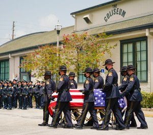 The casket of St. Petersburg Police officer Michael Weiskopf, who died due to COVID-19 complications, is carried by an honor guard on August 31, 2021 in St. Petersburg, Florida.