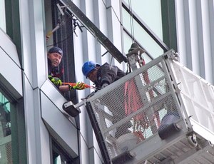 The window washers were not in immediate danger because they were harnessed in, but the firefighters wanted to make sure the men would be all right.
